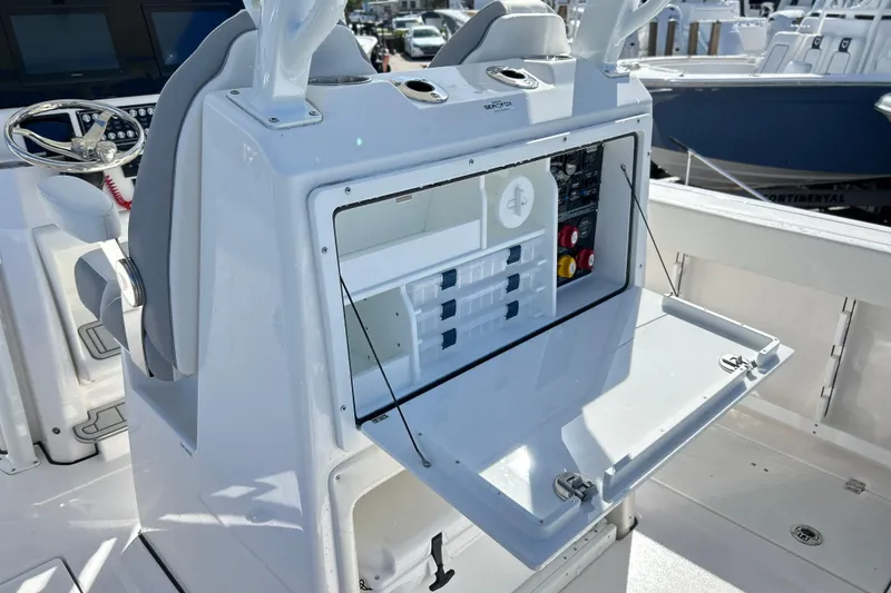 Slide: The Image of 2026 Sea Fox 288 Commander boat console with open storage and control panel. - 18