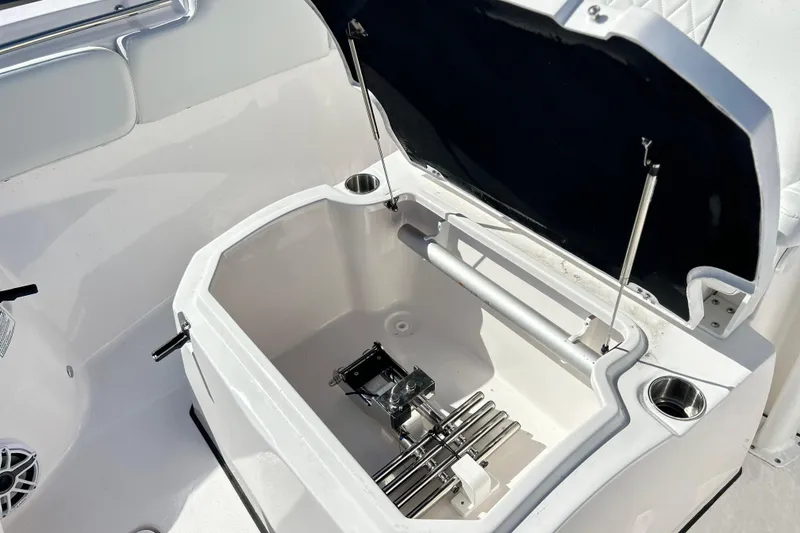 Slide: The Image of 2026 Sea Fox 288 Commander boat storage compartment with open lid and cup holders. - 21