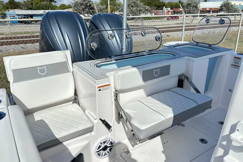 Slide: The Image of 2026 Sea Fox 288 Commander boat interior with cushioned seating and dual outboard motors. - 27