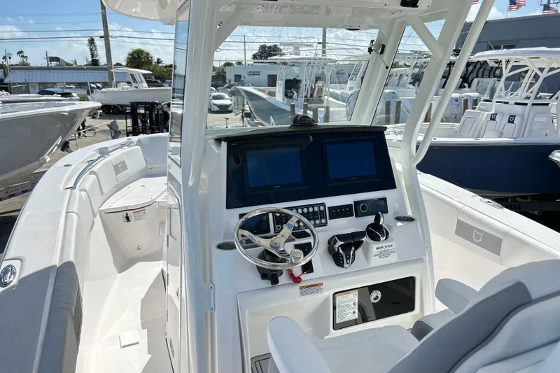 Slide: The Image of 2026 Sea Fox 288 Commander boat interior with dual screens and steering wheel. - 31