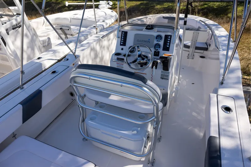Slide: The Image of 2020 Robalo R202 Explorer boat interior with steering console and seating. - 4