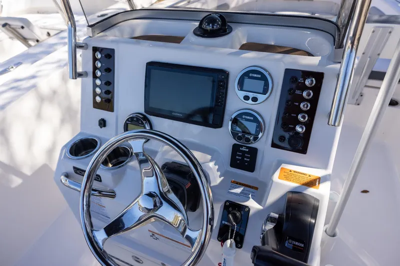 Slide: The Image of 2020 Robalo R202 Explorer boat dashboard with steering wheel and navigation controls. - 8