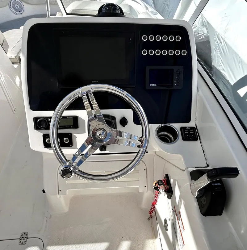 Slide: The Image of Edgewater 348 CX 2020 boat dashboard with steering wheel and control panel. - 14