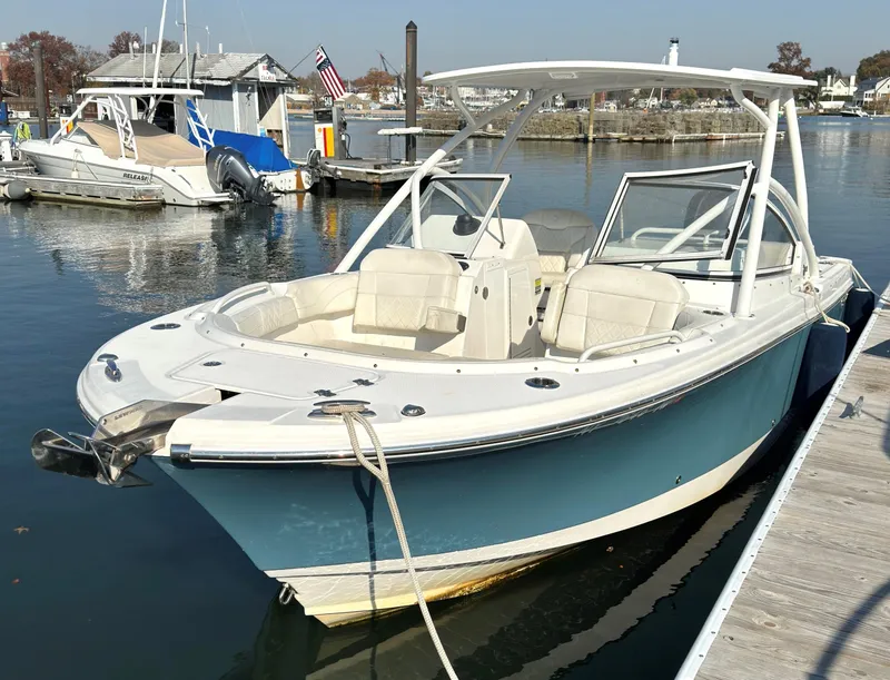 Slide: The Image of 2020 Edgewater 348 CX boat docked in a marina, featuring sleek design and spacious seating. - 2