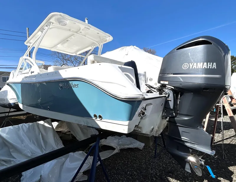 Slide: The Image of 2020 Edgewater 348 CX boat with Yamaha outboard motor, displayed outdoors. - 20