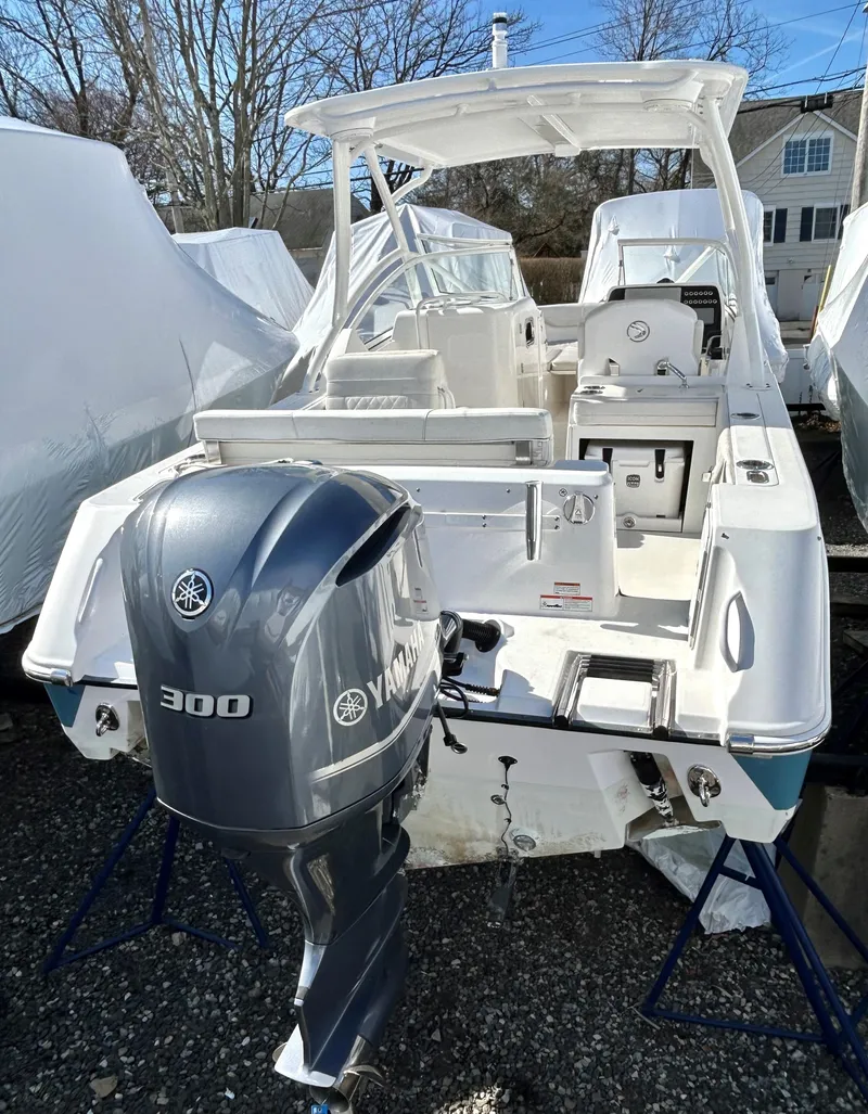 Slide: The Image of 2020 Edgewater 348 CX boat with Yamaha 300 outboard motor, docked outdoors. - 21