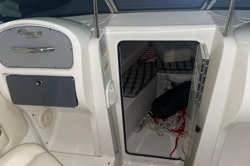 Slide: The Image of 2006 Chris-Craft Corsair 28 cabin interior with seating and storage. - 13