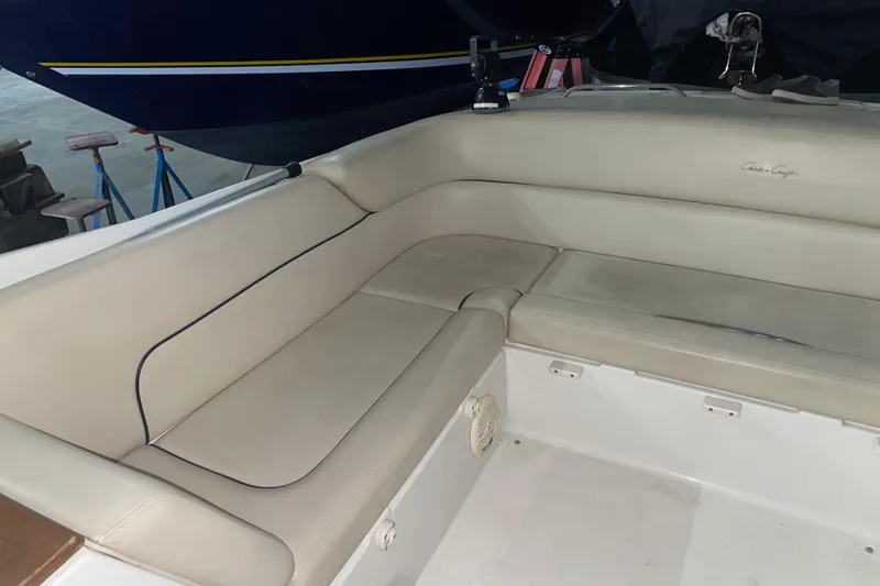 Slide: The Image of 2006 Chris-Craft Corsair 28 boat interior with beige seating in a docked setting. - 4
