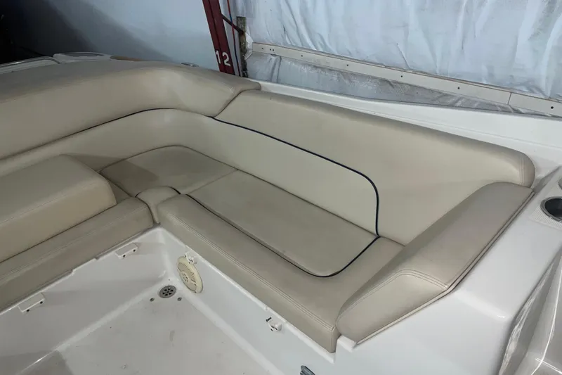 Slide: The Image of 2006 Chris-Craft Corsair 28 boat interior with beige leather seating. - 5