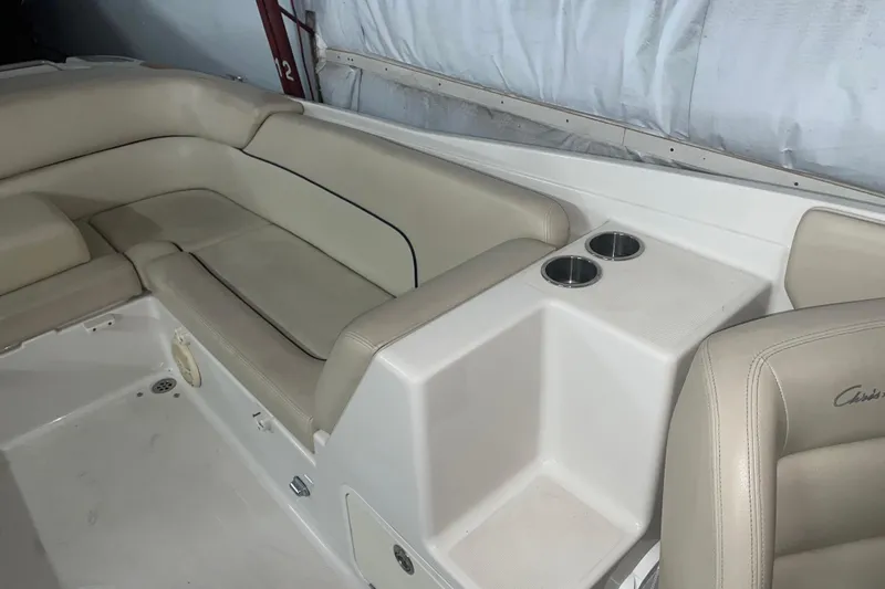 Slide: The Image of 2006 Chris-Craft Corsair 28 boat interior with beige seating and cup holders. - 6