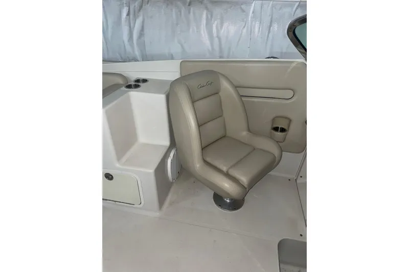 Slide: The Image of 2006 Chris-Craft Corsair 28 boat interior with beige leather seat and cup holders. - 7