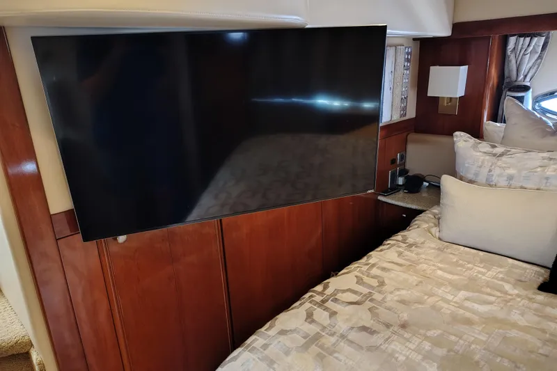 Slide: The Image of Luxurious 2006 Meridian 459 Motoryacht interior with TV and elegant bedding. - 12