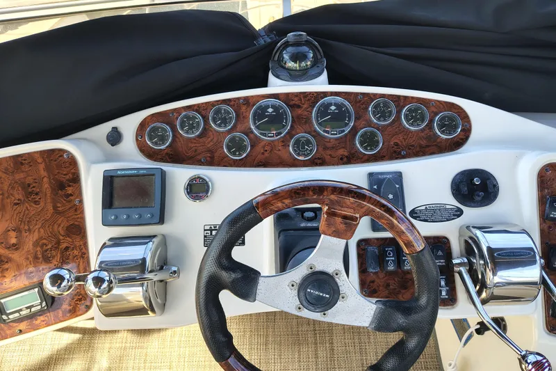 Slide: The Image of 2006 Meridian 459 Motoryacht helm with wood accents and navigation instruments. - 15