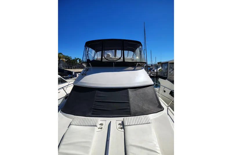 Slide: The Image of 2006 Meridian 459 Motoryacht with sleek design, docked under clear blue sky. - 24