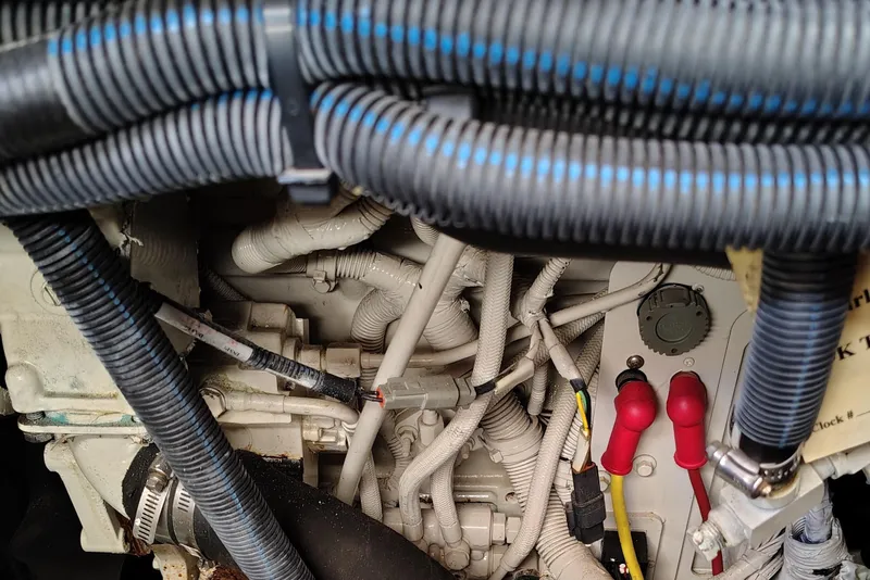 Slide: The Image of Engine compartment of a 2006 Meridian 459 Motoryacht with visible wiring and hoses. - 26