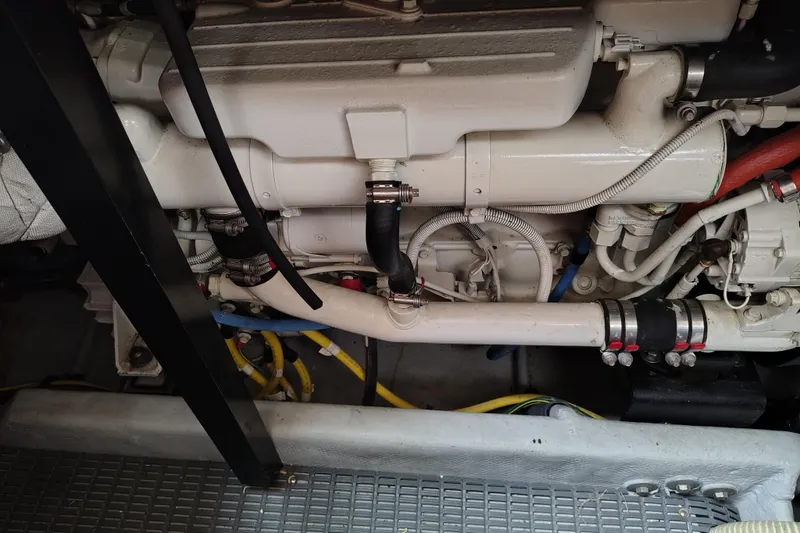 Slide: The Image of Engine compartment of 2006 Meridian 459 Motoryacht, showcasing pipes and hoses. - 27