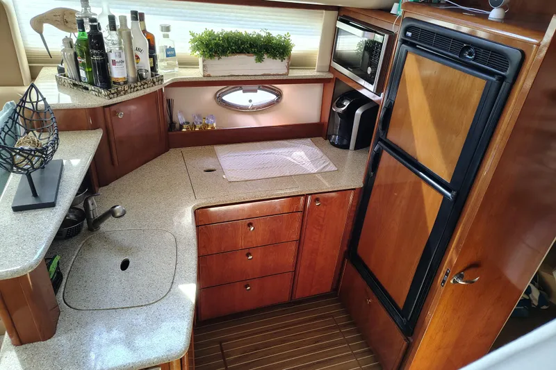 Slide: The Image of Luxurious 2006 Meridian 459 Motoryacht kitchen with modern amenities and elegant wood cabinetry. - 6