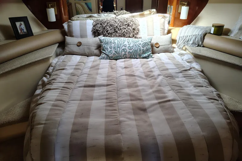 Slide: The Image of Cozy bedroom in 2006 Meridian 459 Motoryacht with striped bedding and decorative pillows. - 8