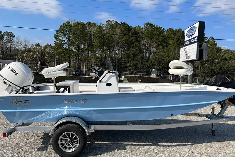 Slide: The Image of 2026 G3 Bay 17 boat with Yamaha engine on trailer, parked outdoors. - 2