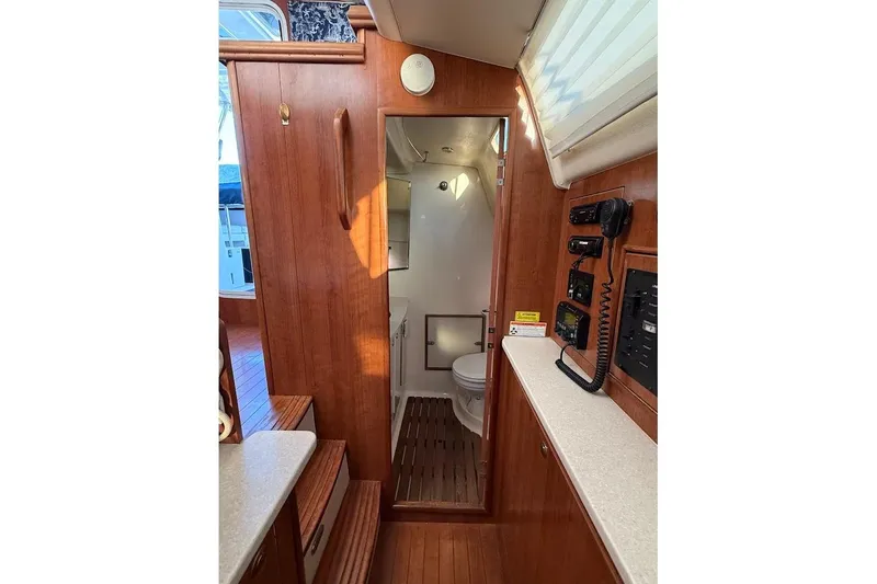 Slide: The Image of Interior of 2013 Gemini Legacy 35 yacht, featuring wooden cabinetry and compact bathroom. - 12