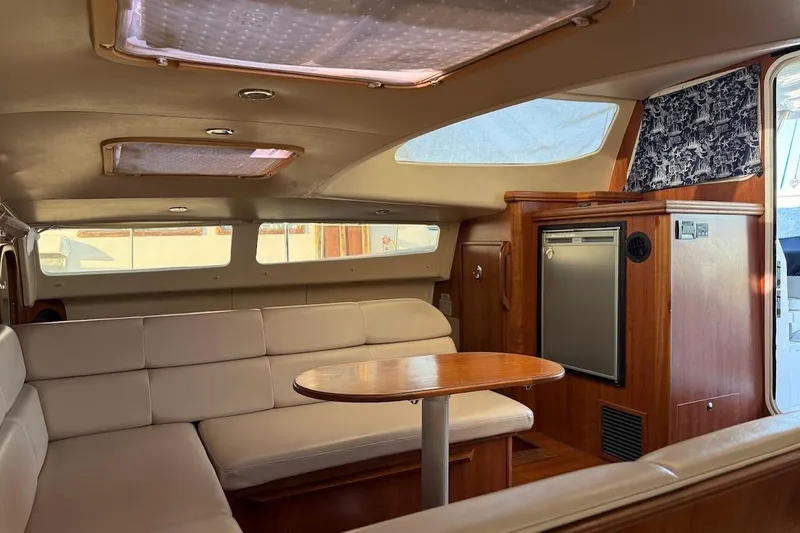 Slide: The Image of Interior of 2013 Gemini Legacy 35 yacht with beige seating and wooden table. - 13
