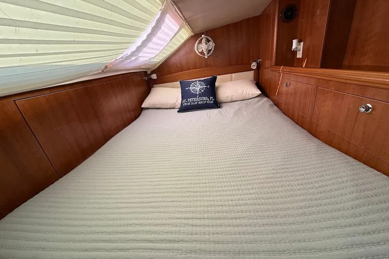 Slide: The Image of Cozy cabin bedroom in 2013 Gemini Legacy 35 sailboat with wooden interior and nautical decor. - 14