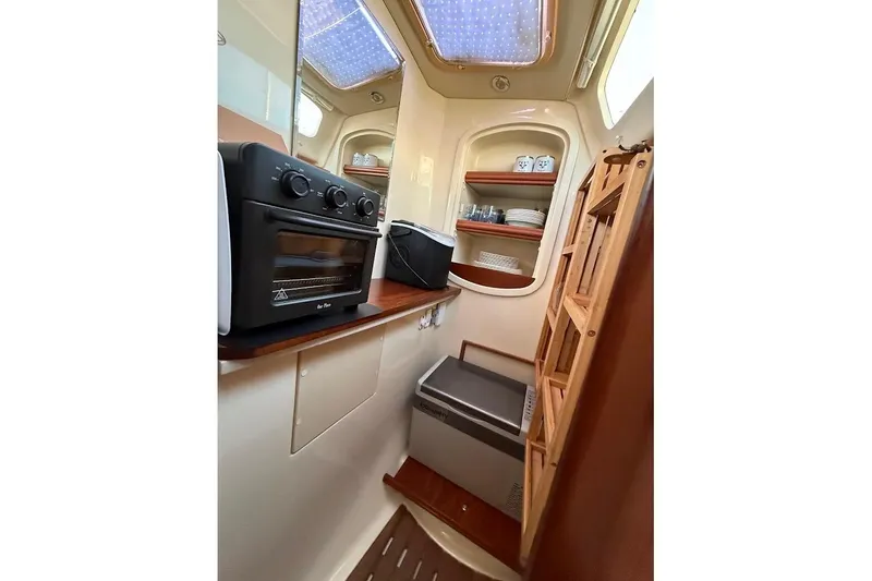 Slide: The Image of Compact kitchen in 2013 Gemini Legacy 35 boat with oven, shelves, and storage. - 16