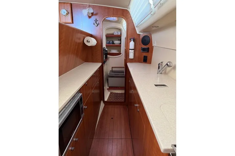 Slide: The Image of Interior of 2013 Gemini Legacy 35 yacht kitchen with wood cabinetry and modern appliances. - 17