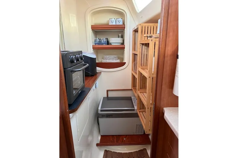 Slide: The Image of Compact kitchen in 2013 Gemini Legacy 35 boat with oven, shelves, and storage. - 18