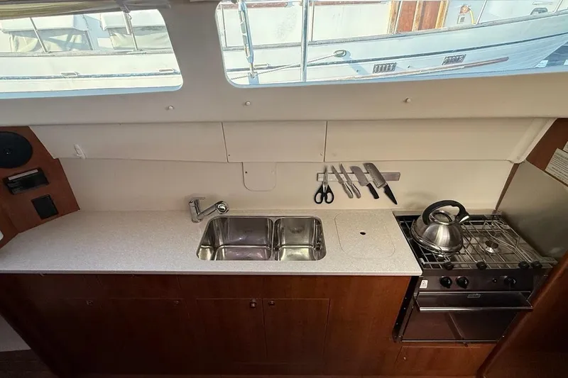 Slide: The Image of Compact kitchen in a 2013 Gemini Legacy 35 yacht with sink, stove, and utensils. - 19
