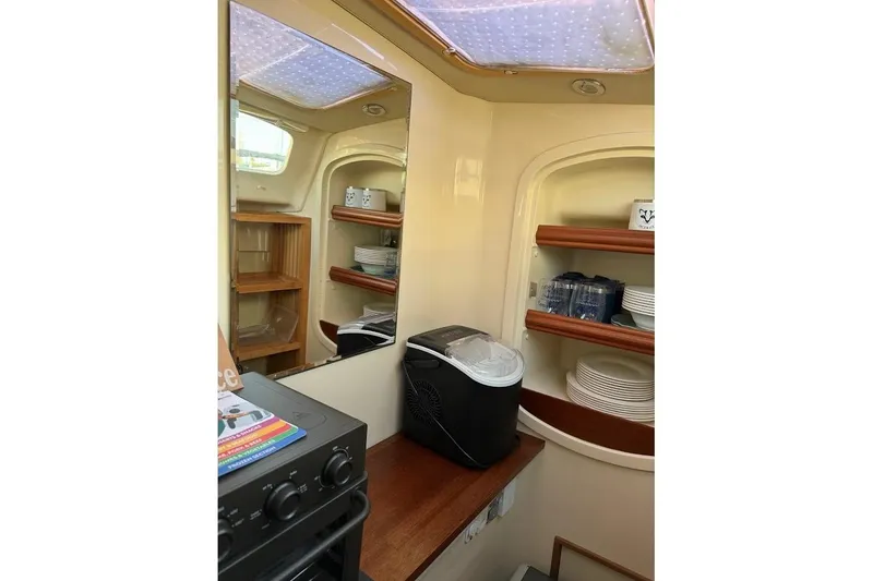Slide: The Image of Interior of 2013 Gemini Legacy 35 boat with kitchen shelves and appliances. - 24
