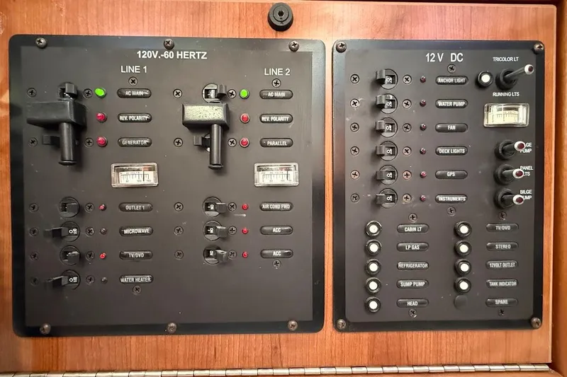 Slide: The Image of Electrical control panel of a 2013 Gemini Legacy 35 boat, featuring switches and indicators. - 27