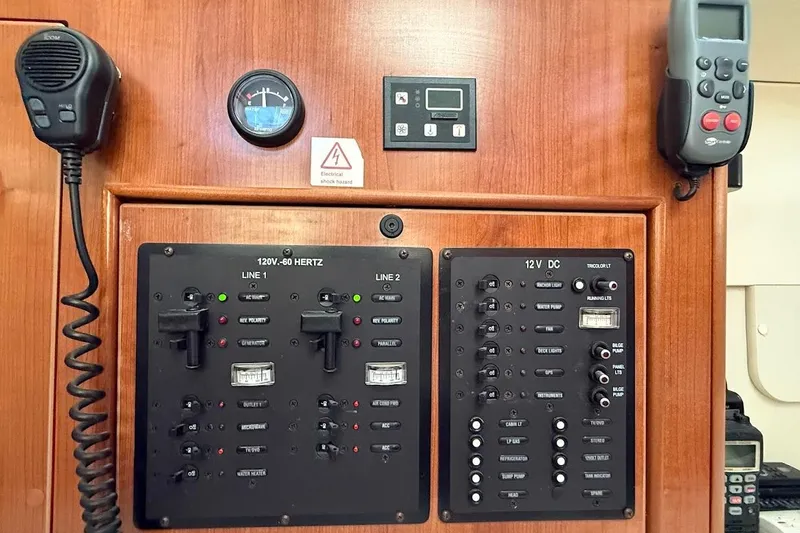 Slide: The Image of Electrical control panel on a 2013 Gemini Legacy 35 boat, featuring switches and meters. - 28