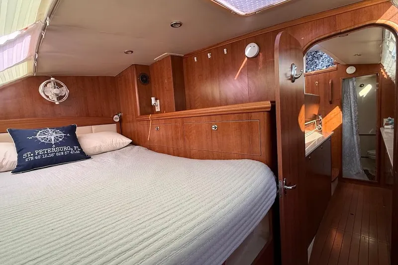 Slide: The Image of Cozy cabin interior of 2013 Gemini Legacy 35 sailboat with wood paneling and comfortable bedding. - 32