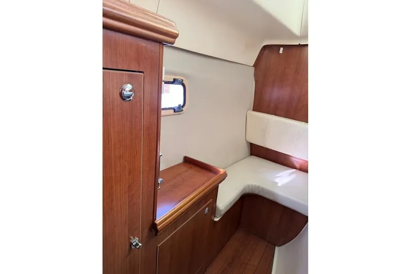 Slide: The Image of Interior of 2013 Gemini Legacy 35 sailboat with wood finish and cushioned seating. - 33
