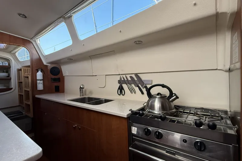 Slide: The Image of Interior of 2013 Gemini Legacy 35 yacht kitchen with stove, sink, and knife set. - 8