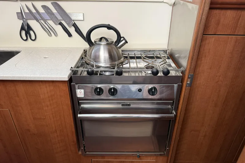 Slide: The Image of Compact kitchen in 2013 Gemini Legacy 35 with stove, kettle, and knife set. - 9