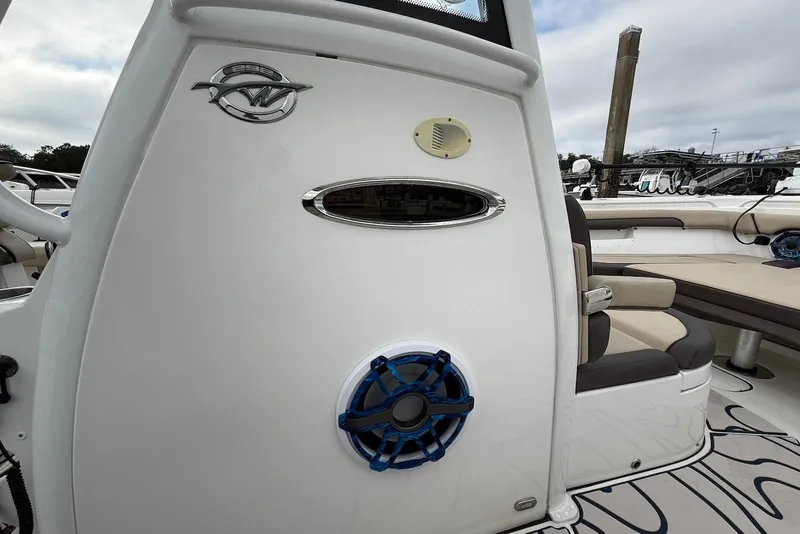 Slide: The Image of 2022 Tidewater 292 CC Adventure boat interior with seating and speaker detail. - 12