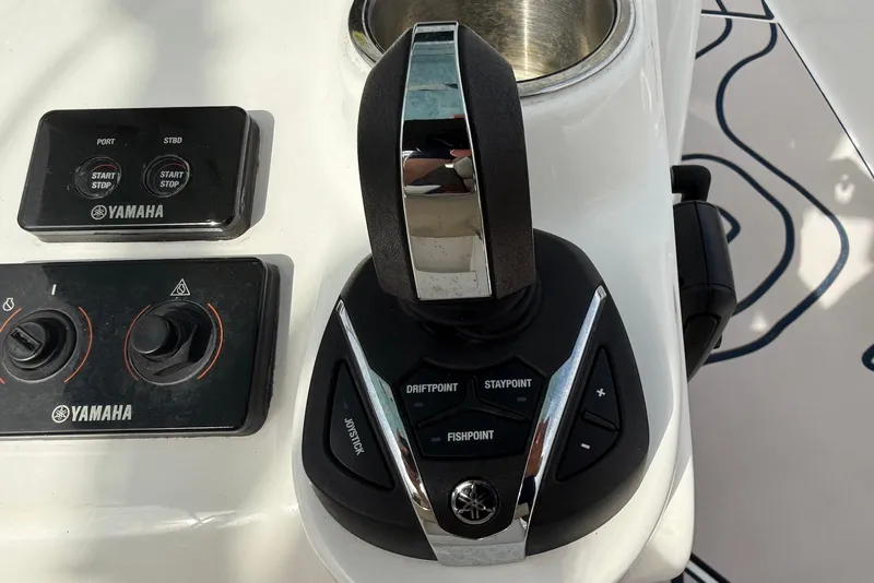 Slide: The Image of Yamaha controls on 2022 Tidewater 292 CC Adventure boat dashboard. - 17