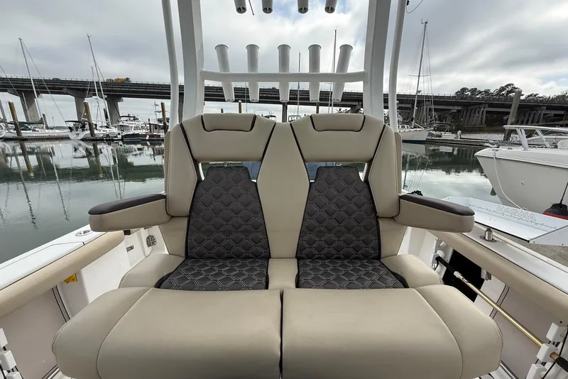 Slide: The Image of 2022 Tidewater 292 CC Adventure boat seats with quilted design, docked near marina. - 21