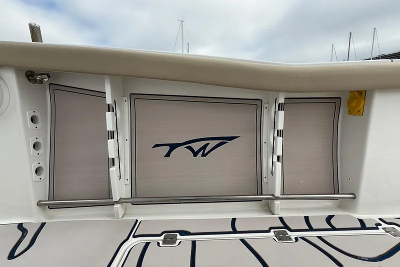 Slide: The Image of 2022 Tidewater 292 CC Adventure boat interior with logo and storage compartments. - 23