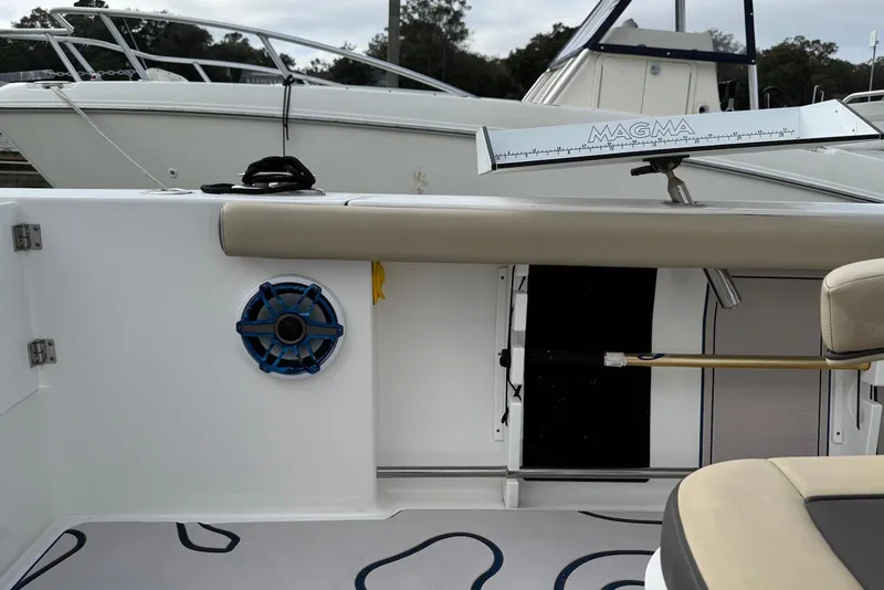 Slide: The Image of 2022 Tidewater 292 CC Adventure boat interior with speaker and Magma grill. - 26