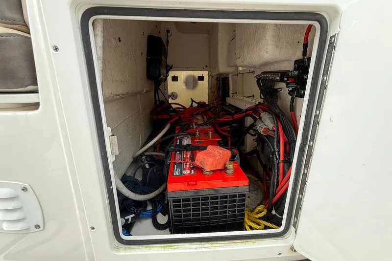 Slide: The Image of Battery compartment of 2022 Tidewater 292 CC Adventure boat, showing wiring and connections. - 33