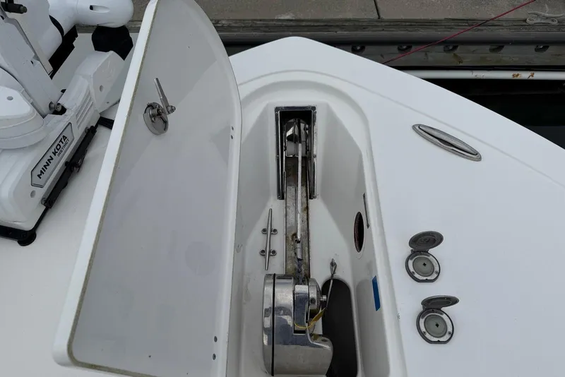 Slide: The Image of 2022 Tidewater 292 CC Adventure boat anchor compartment with Minn Kota motor. - 34