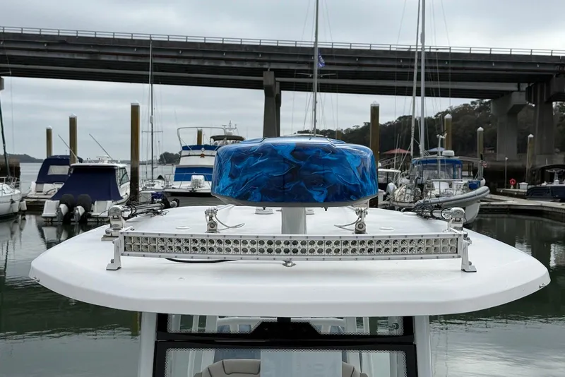 Slide: The Image of 2022 Tidewater 292 CC Adventure boat docked, featuring a blue radar dome and LED light bar. - 5