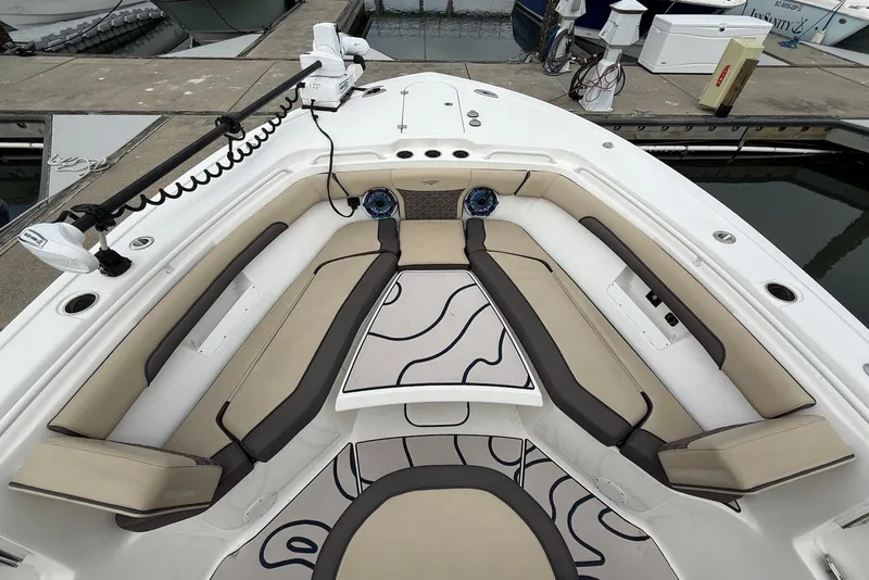 Slide: The Image of 2022 Tidewater 292 CC Adventure boat interior with cushioned seating and modern design. - 7