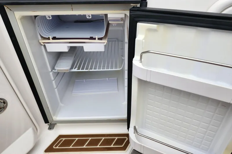 Slide: The Image of 2011 Regal 3060 Express Cruiser interior with white seating and wood flooring. - 11