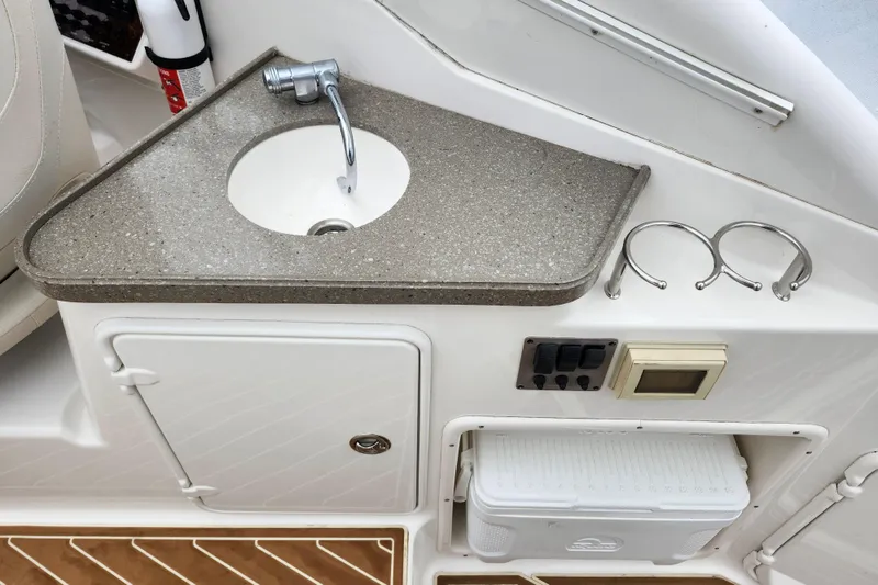 Slide: The Image of 2011 Regal 3060 Express Cruiser interior with sink, storage, and fire extinguisher. - 15