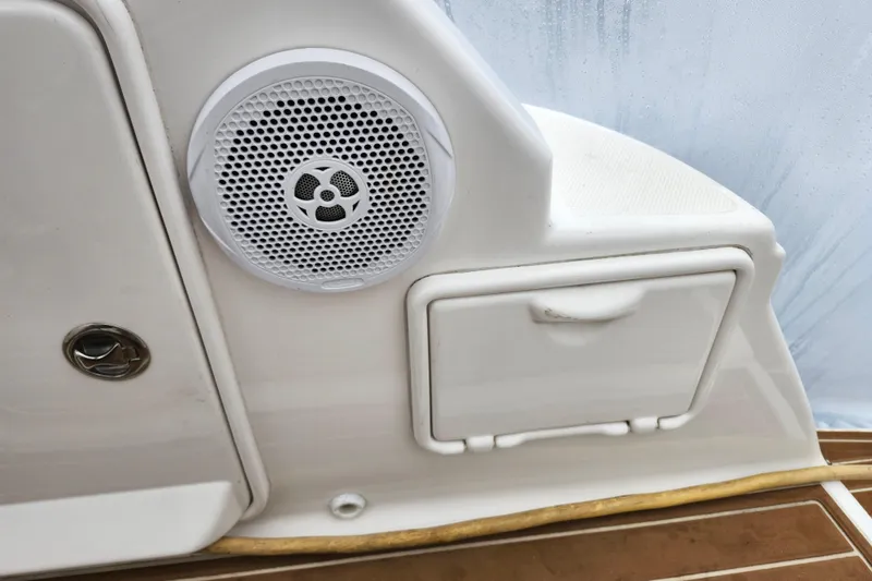 Slide: The Image of 2011 Regal 3060 Express Cruiser sink area with countertop, cup holders, and storage. - 16