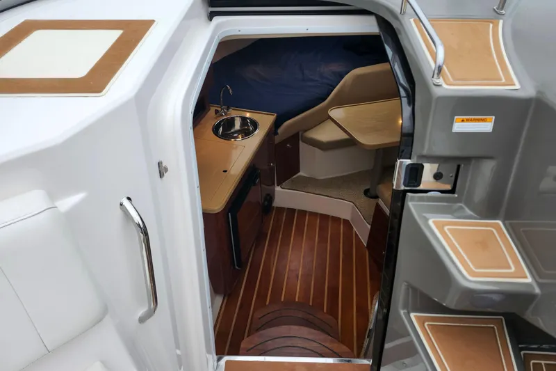 Slide: The Image of 2011 Regal 3060 Express Cruiser cabin entrance with sleek design and modern interior. - 23